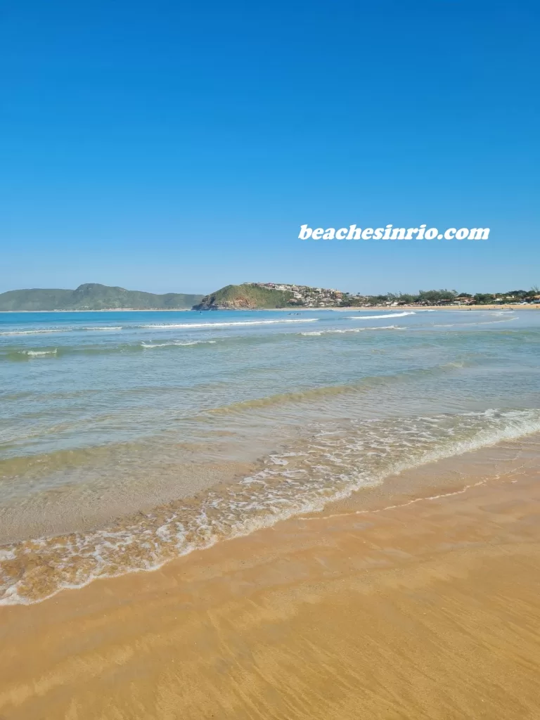 Beautiful natural scenery of Geriba Beach in Buzios, Brazil, with golden sand and crystal-clear waters under the Rio de Janeiro winter sun.