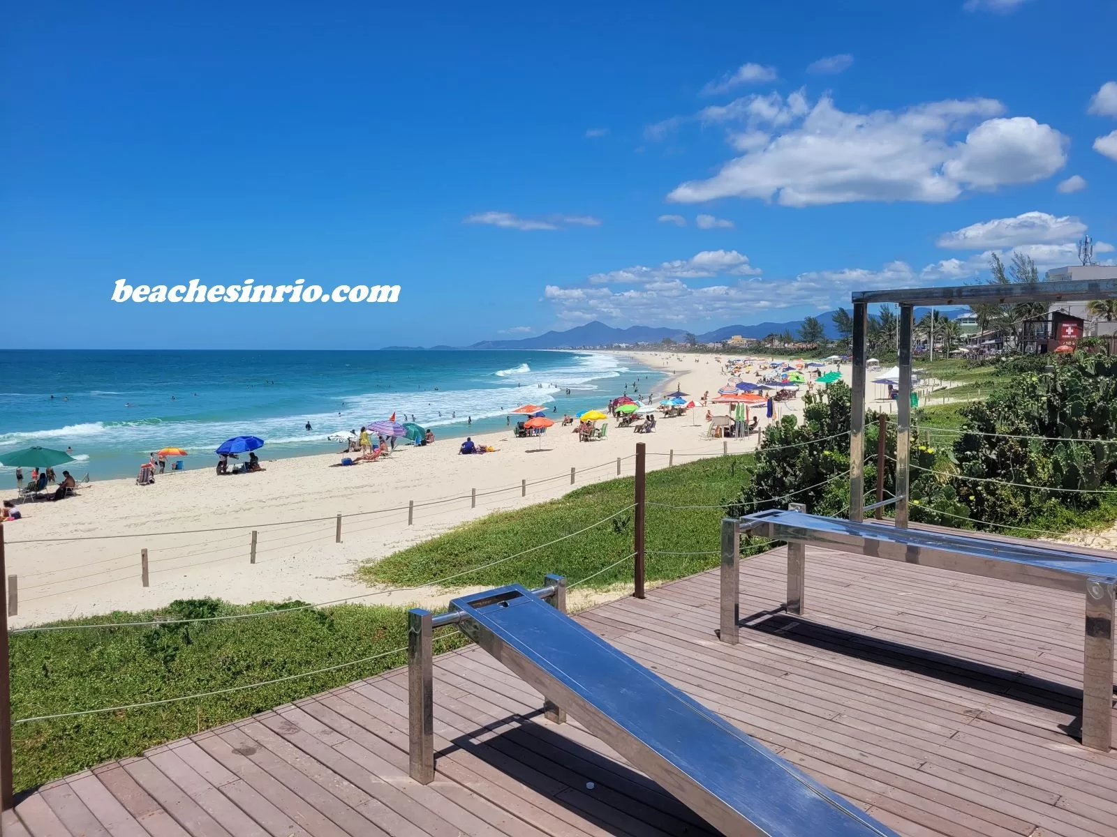 Sunny winter day at Praia da Vila, featuring clear blue waters, white sand, and great waves in Saquarema.