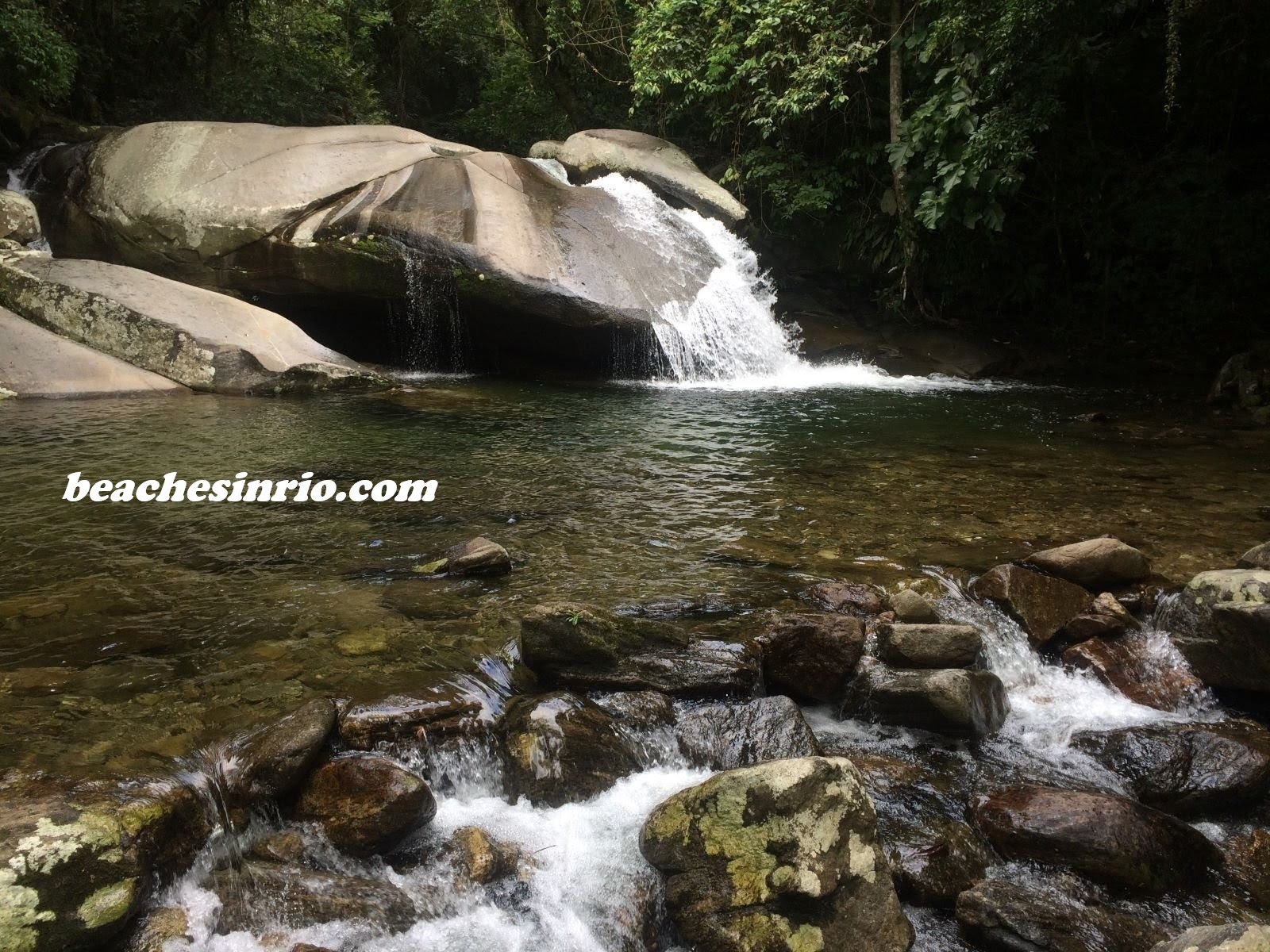 Atlantic Forest with crystal-clear emerald-green waters in a natural pool at the Bridal Veil waterfall in Muriqui, Mangaratiba.